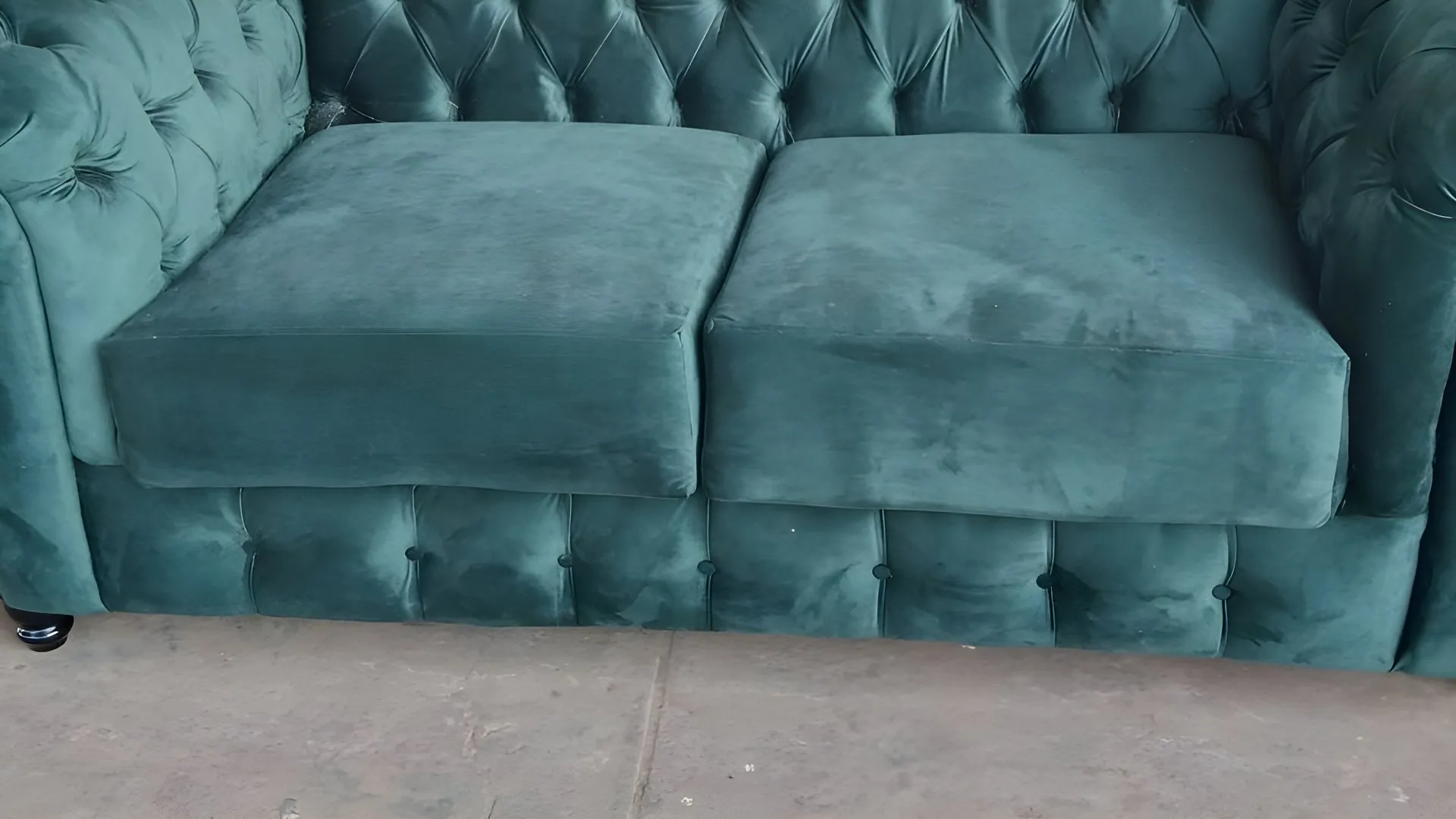 After: Red-and-black chesterfield, re-covered in teal velvet
