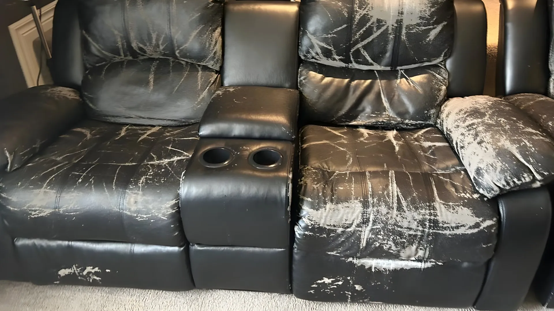 Before: Peeling black recliner, redone in tan