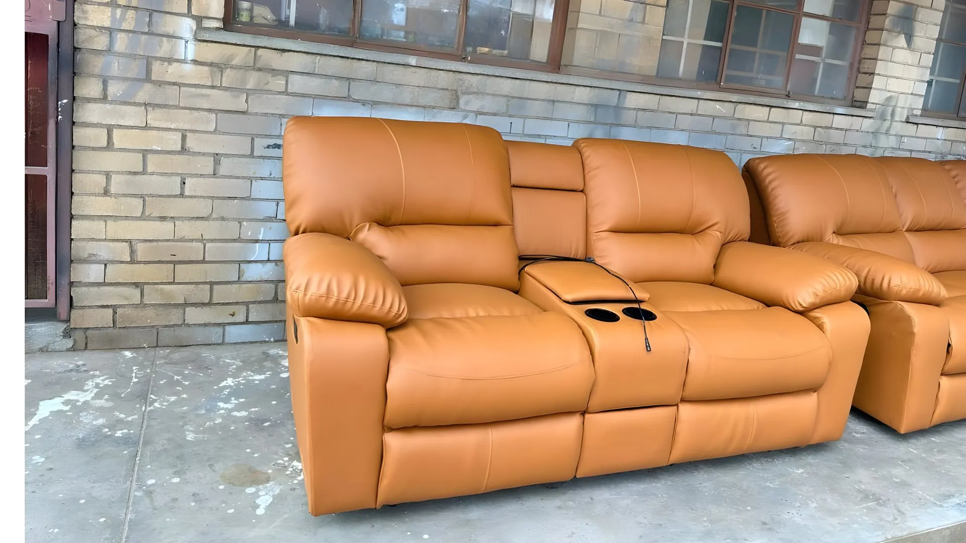 After: Brown two-seater recliner with cup holders, redone in tan