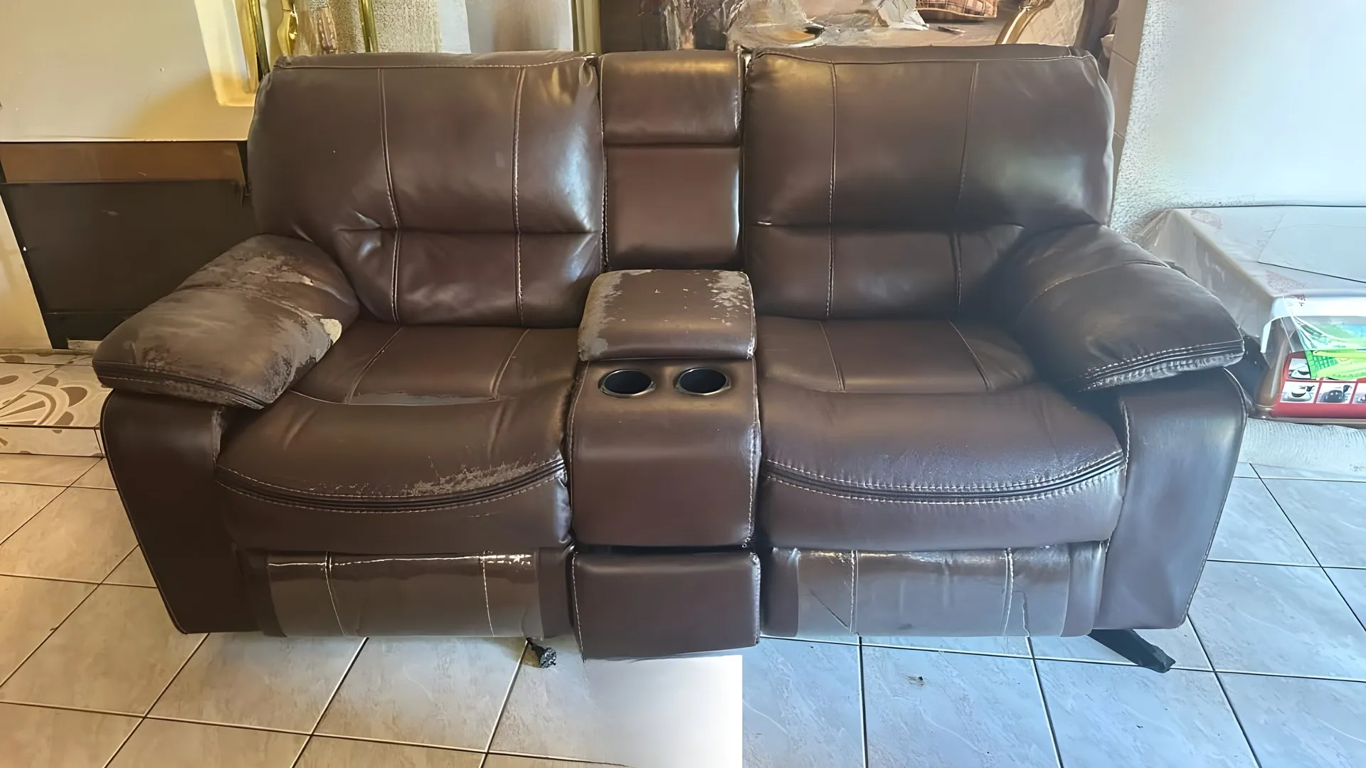 Before: Brown two-seater recliner with cup holders, redone in tan