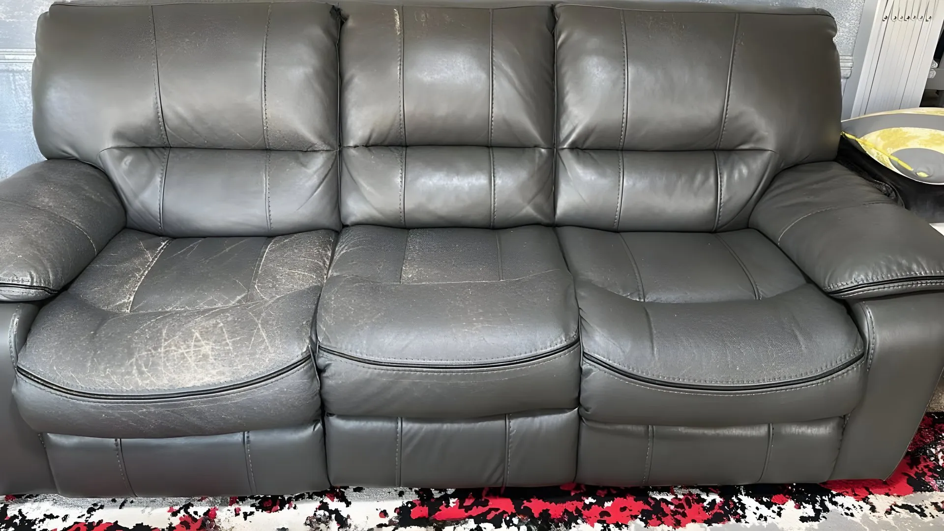Before: Cracked grey three-seater recliner, re-covered in grey