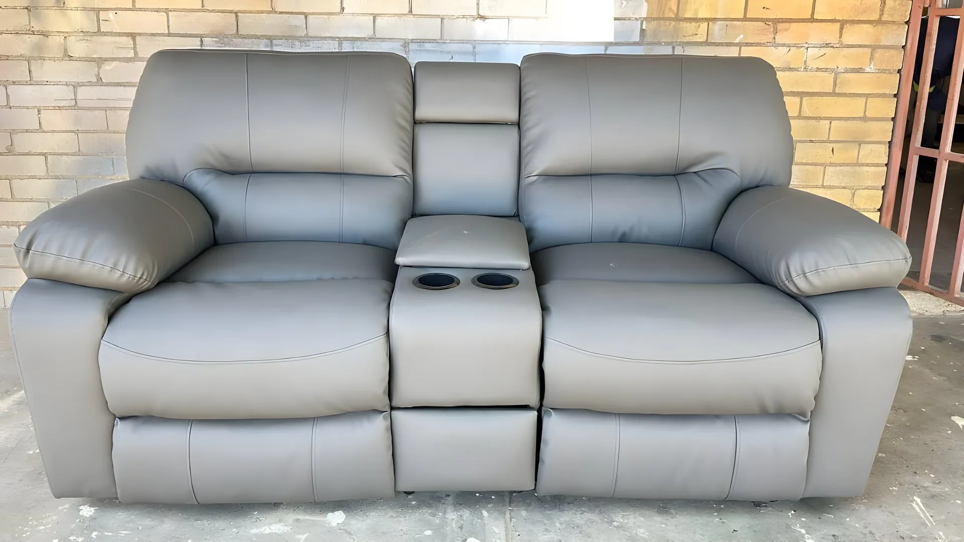 After: Grey two-seater recliner with console, re-covered in grey