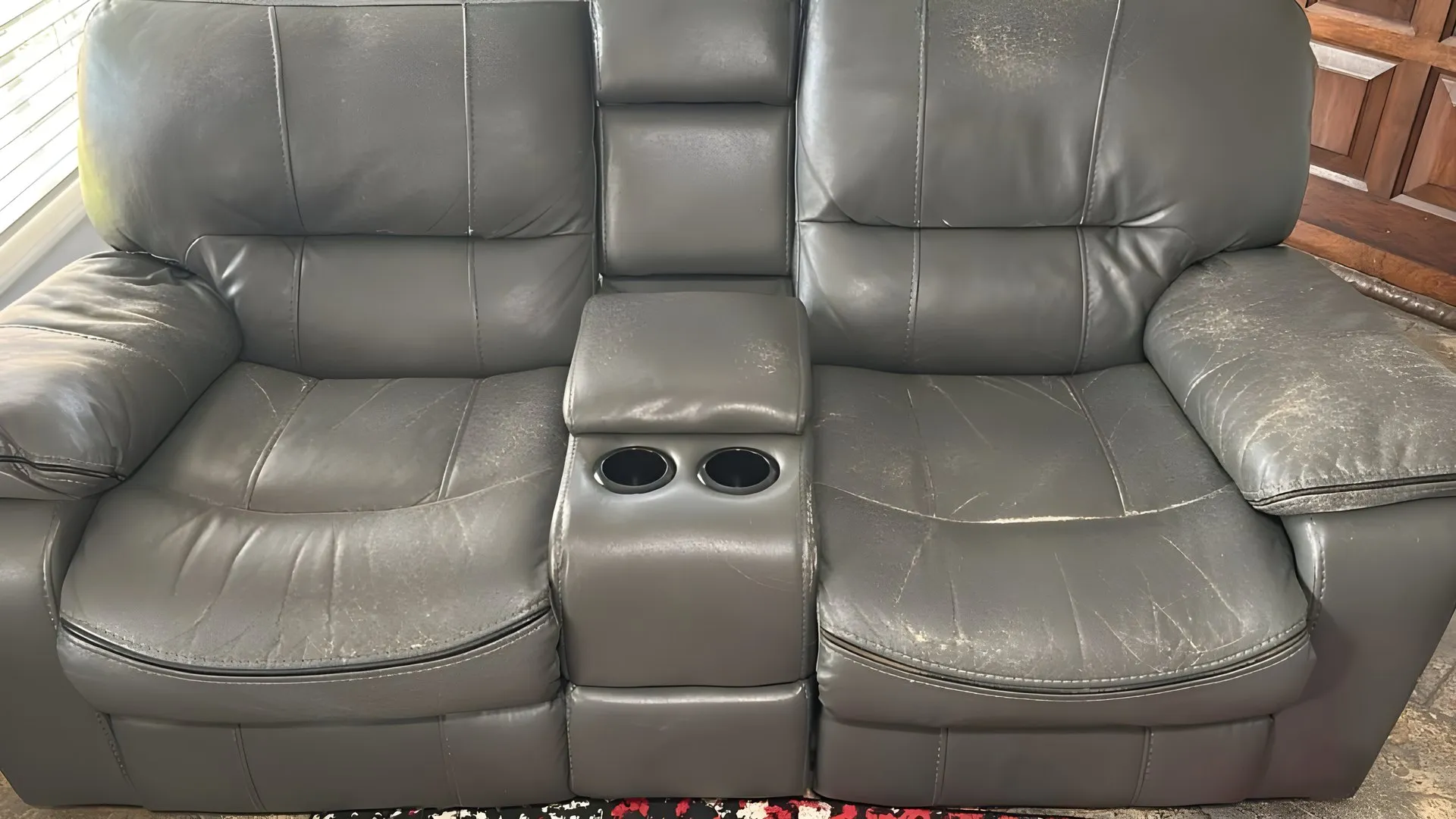 Before: Grey two-seater recliner with console, re-covered in grey
