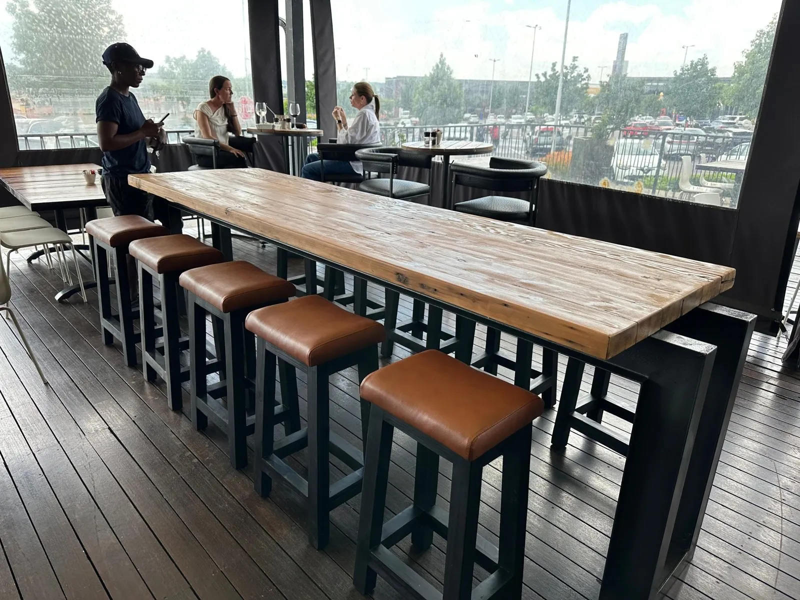 Row of bar stools with tan leather seats at a restaurant counter