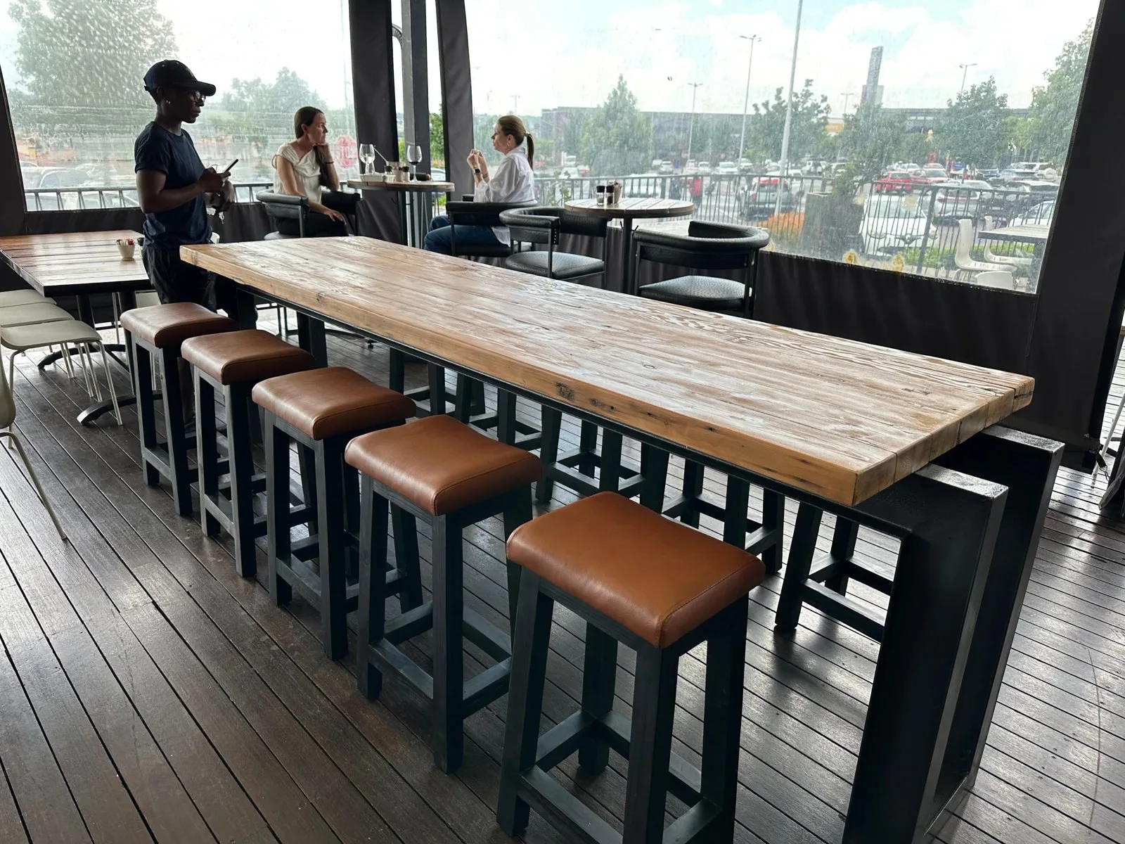 Bar stools with tan leather seats along a restaurant counter