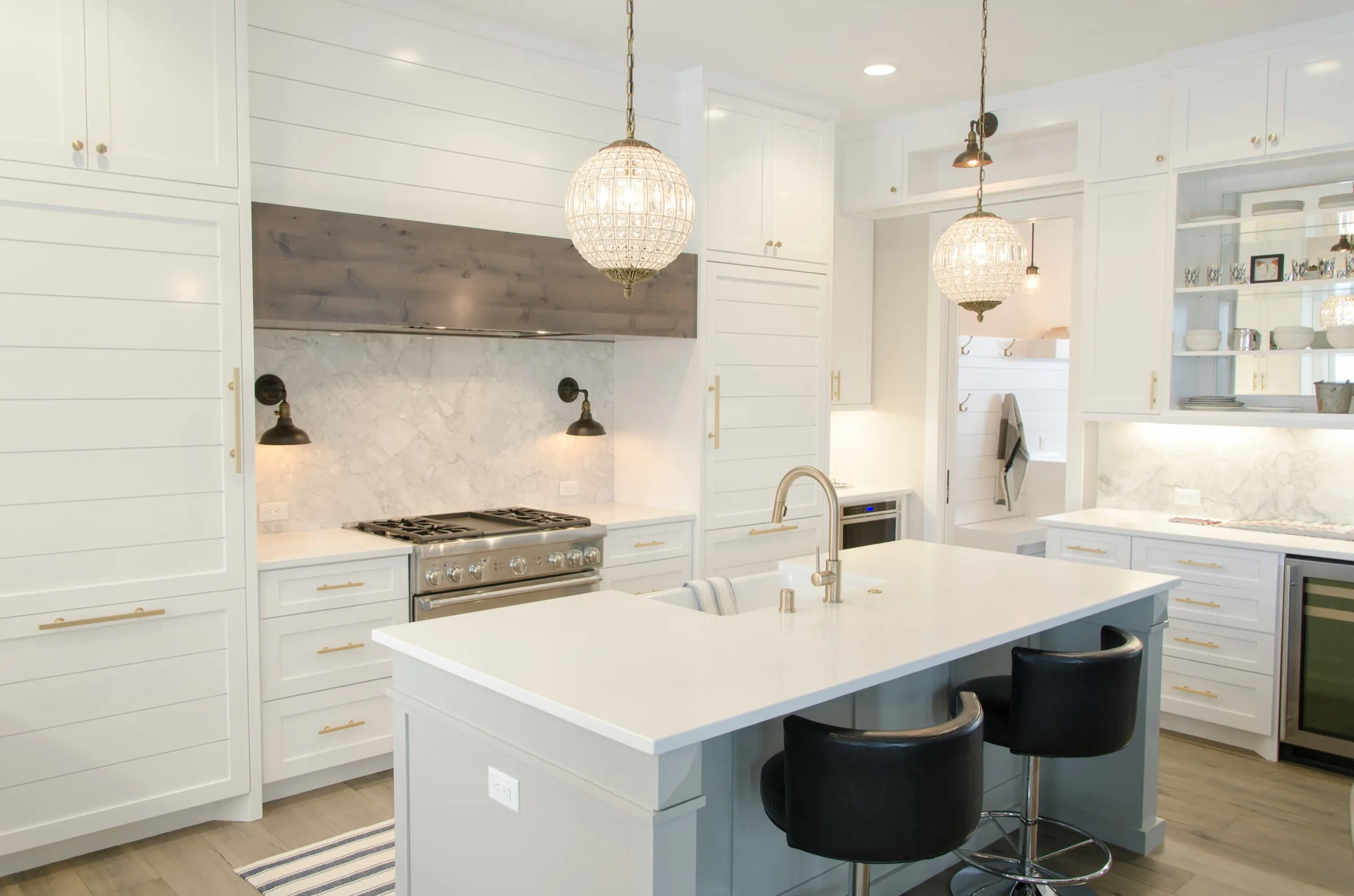 Example only, not a Trysofic job: white shaker kitchen with a marble splashback and an island