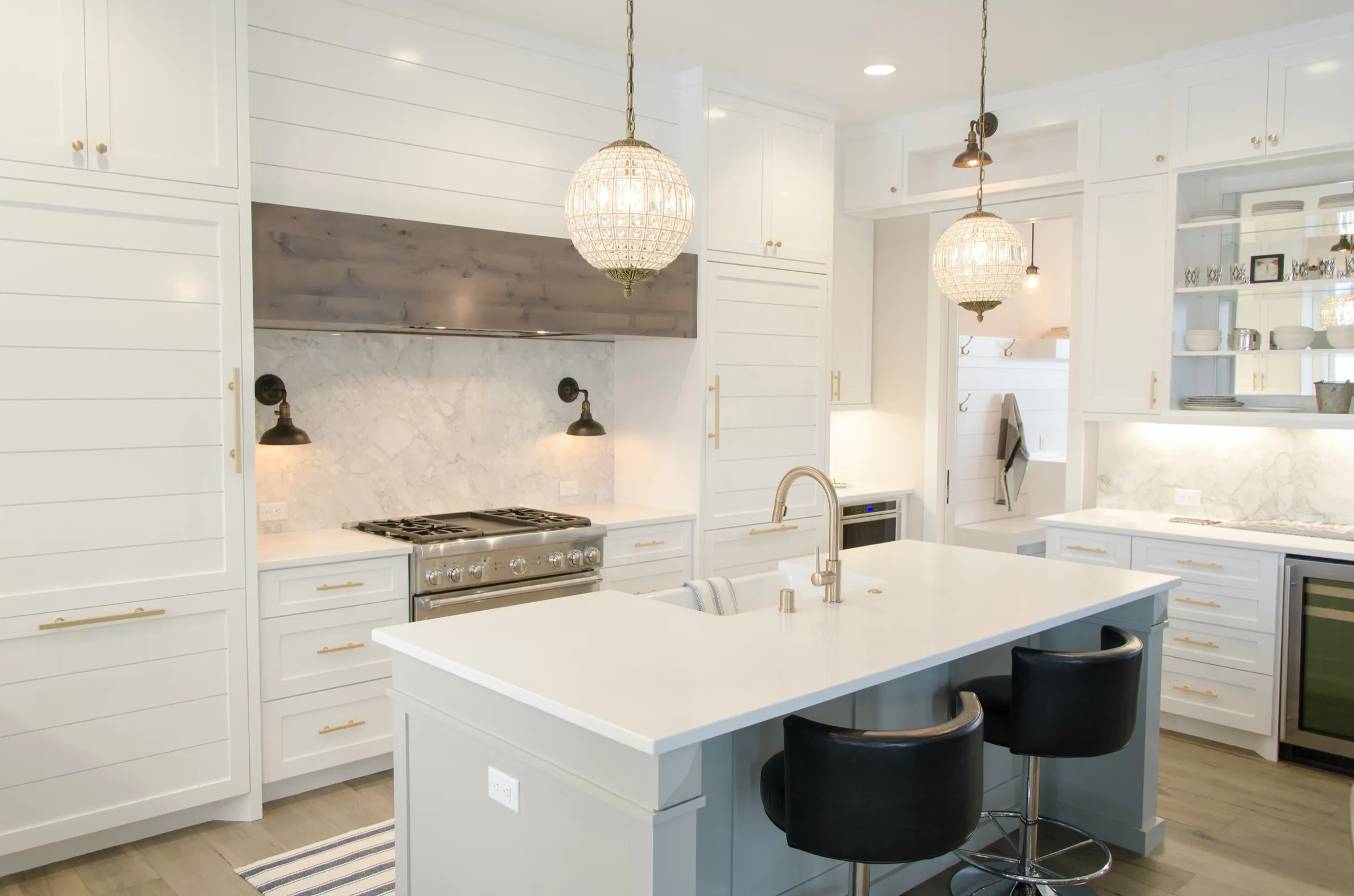 Example only, not a Trysofic job: white shaker kitchen with a marble splashback and an island