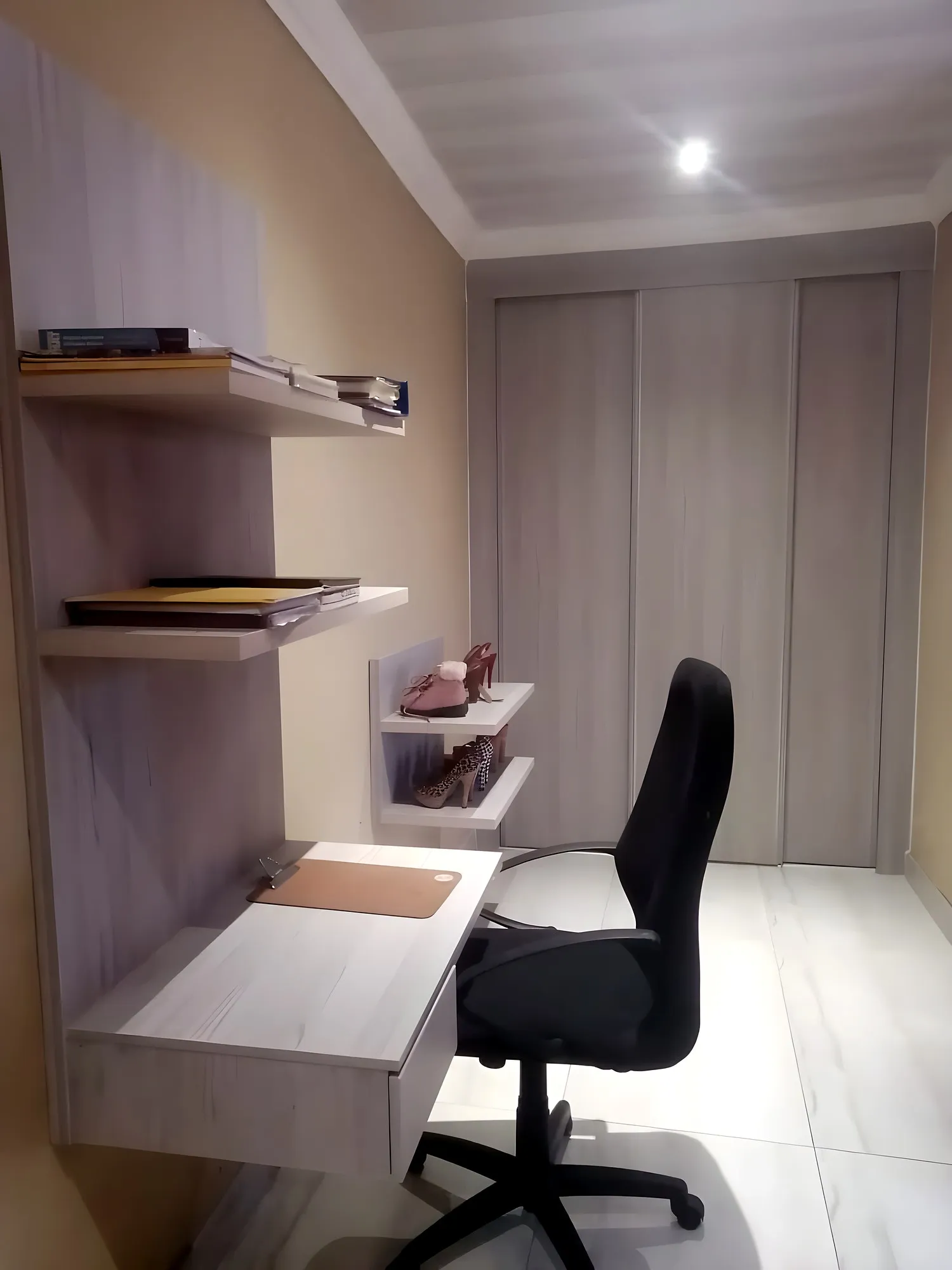 Light oak sliding wardrobe with floating shelves and a built-in study desk